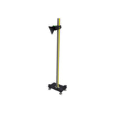 Black triangular reflector mounted on adjustable yellow and green pole with black base stand.