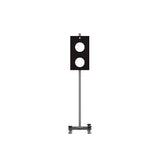 Black rectangular panel with two white circular cutouts mounted on gray pole with base bracket.